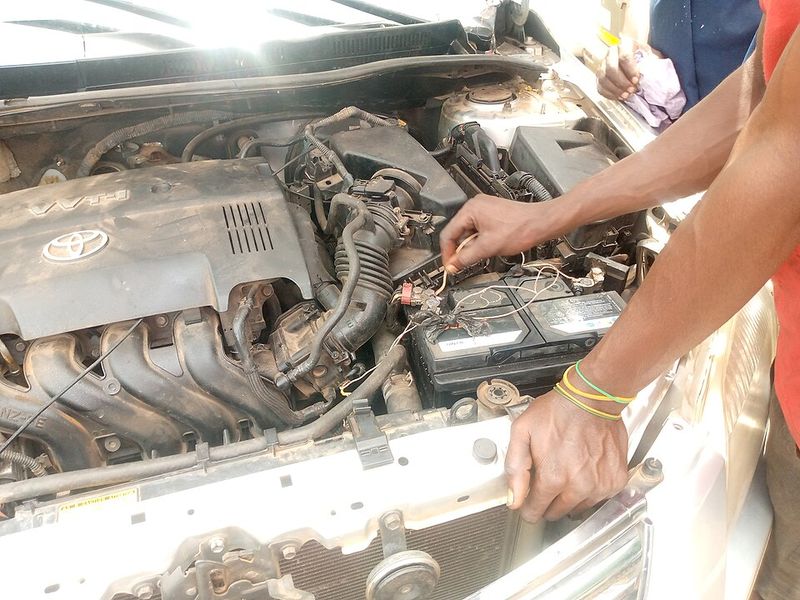Mechanic fitting a car battery
